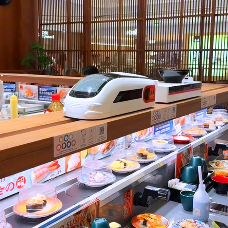 Sistema transportador de sushi giratorio automático